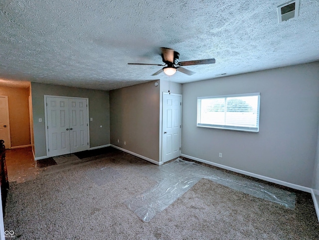 301 W Davis St, Greensburg, IN 47240 - unfurnished bedroom featuring carpet, baseboards, a textured ceiling, ceiling fan, and a closet