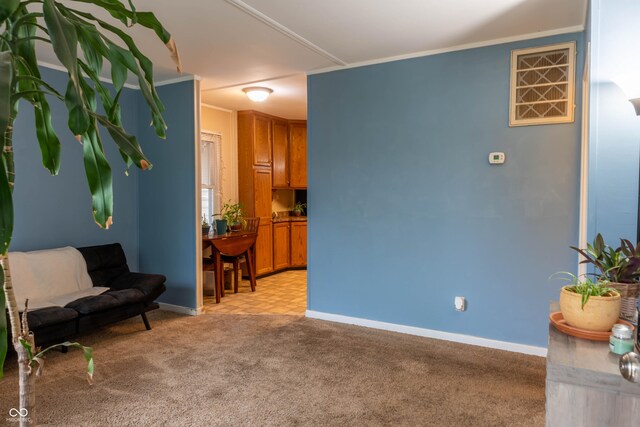 2620 13th St, Columbus, IN 47201 - living area with light carpet, baseboards, and crown molding