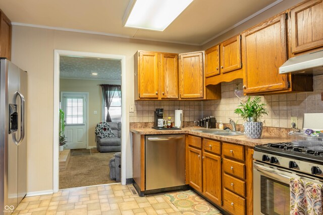 2620 13th St, Columbus, IN 47201 - kitchen with appliances with stainless steel finishes, baseboards, a sink, backsplash, and light countertops