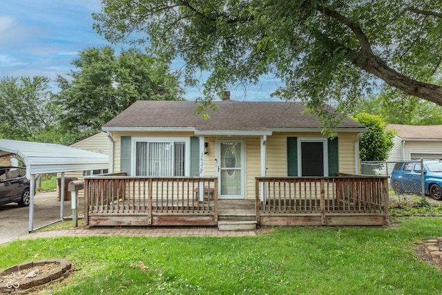 2620 13th St, Columbus, IN 47201 - view of front of house featuring a front yard, a shingled roof, a carport, and covered porch