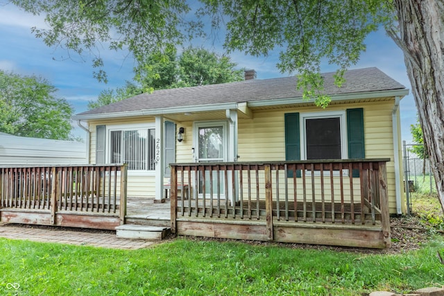 2620 13th St, Columbus, IN 47201 - view of front of home with a shingled roof, a chimney, and a deck
