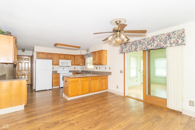 391 W 500 S, Anderson, IN 46013 - kitchen featuring white appliances, a peninsula, wood finished floors, a ceiling fan, and light countertops