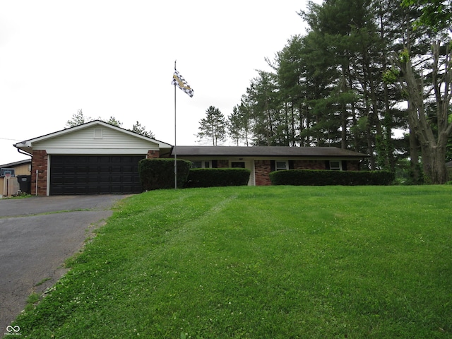2907 Jay Dee Ln, Greenwood, IN 46143 - single story home with asphalt driveway, an attached garage, a front lawn, and brick siding