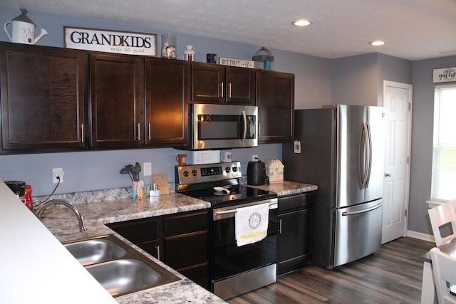 12901 N Collett Way, Camby, IN 46113 - kitchen featuring stainless steel appliances, dark wood-style flooring, dark brown cabinets, a sink, and recessed lighting
