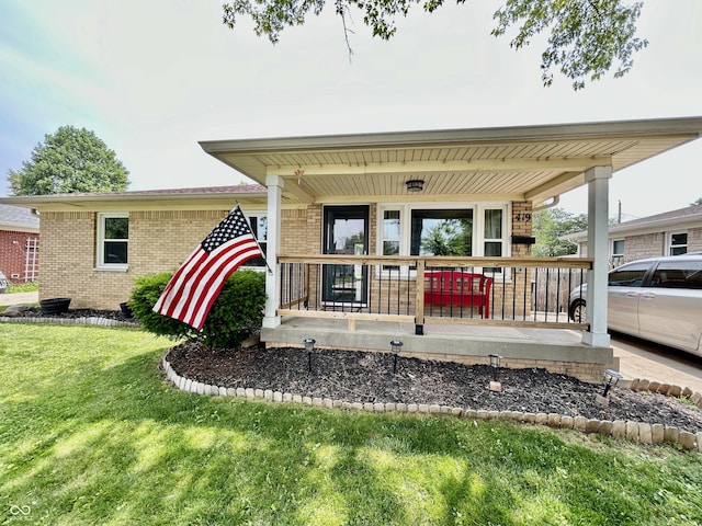 419 N 14th Ave, Beech Grove, IN 46107 - entrance to property with covered porch, brick siding, and a yard