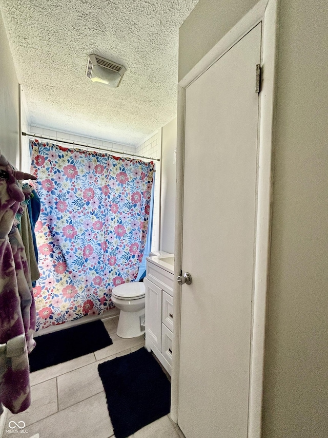 419 N 14th Ave, Beech Grove, IN 46107 - bathroom featuring a textured ceiling, tile patterned floors, vanity, and a shower with shower curtain
