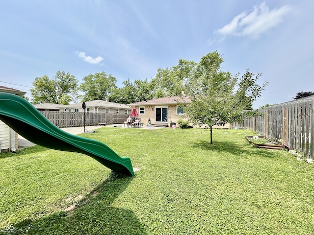 419 N 14th Ave, Beech Grove, IN 46107 - fenced backyard with a playground and a patio area