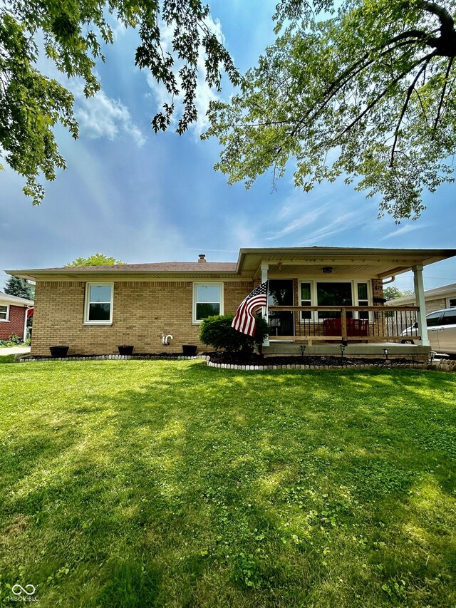 419 N 14th Ave, Beech Grove, IN 46107 - back of house with brick siding and a lawn
