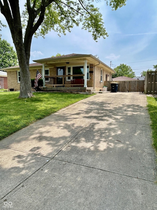 419 N 14th Ave, Beech Grove, IN 46107 - ranch-style home featuring brick siding, a porch, and concrete driveway