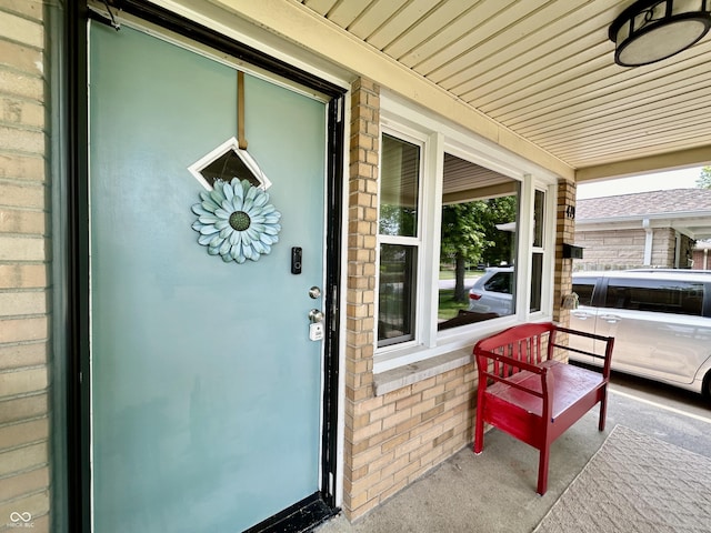 419 N 14th Ave, Beech Grove, IN 46107 - view of exterior entry featuring a porch and brick siding