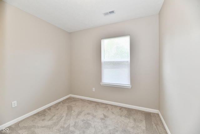 2026 Spruce St, Indianapolis, IN 46203 - spare room with carpet floors and baseboards