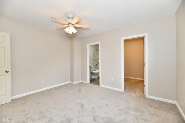 2026 Spruce St, Indianapolis, IN 46203 - unfurnished bedroom featuring carpet, a walk in closet, baseboards, and connected bathroom