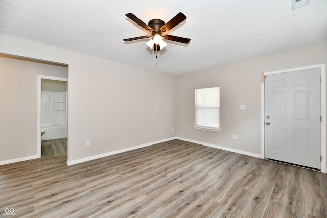 2026 Spruce St, Indianapolis, IN 46203 - unfurnished room with wood finished floors, ceiling fan, and baseboards