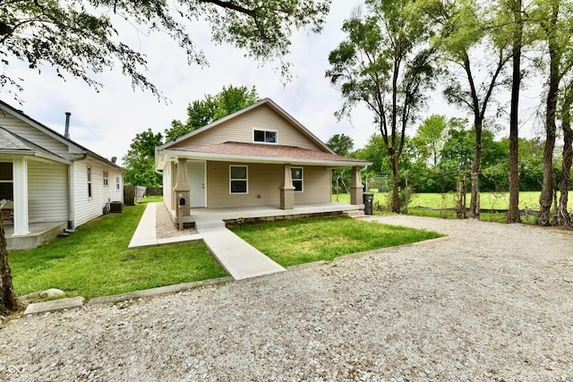 2026 Spruce St, Indianapolis, IN 46203 - back of property with covered porch and a lawn