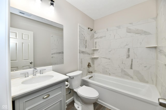 2026 Spruce St, Indianapolis, IN 46203 - bathroom with toilet, vanity, bathtub / shower combination, and wood finished floors