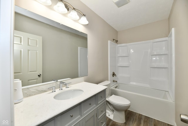 2026 Spruce St, Indianapolis, IN 46203 - bathroom with wood finished floors, toilet, vanity, and  shower combination