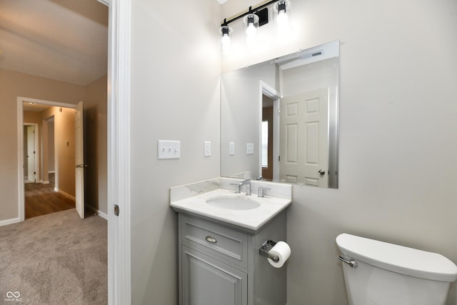 2026 Spruce St, Indianapolis, IN 46203 - bathroom with toilet, vanity, and baseboards