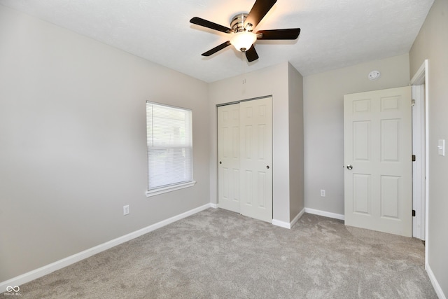 2026 Spruce St, Indianapolis, IN 46203 - unfurnished bedroom with a closet, carpet, baseboards, and a ceiling fan