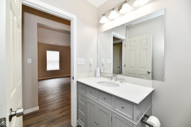 2026 Spruce St, Indianapolis, IN 46203 - bathroom with vanity, wood finished floors, and baseboards