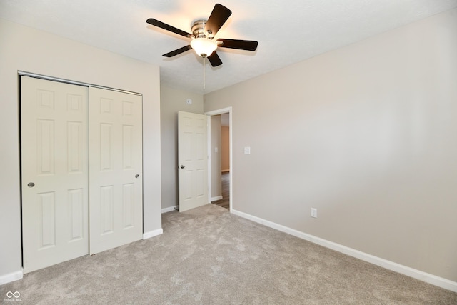 2026 Spruce St, Indianapolis, IN 46203 - unfurnished bedroom with light carpet, a closet, baseboards, and ceiling fan