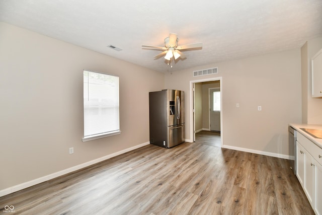 2026 Spruce St, Indianapolis, IN 46203 - unfurnished room with a ceiling fan, light wood-style floors, and baseboards