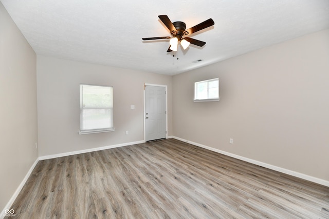 2026 Spruce St, Indianapolis, IN 46203 - empty room featuring wood finished floors, baseboards, and a ceiling fan