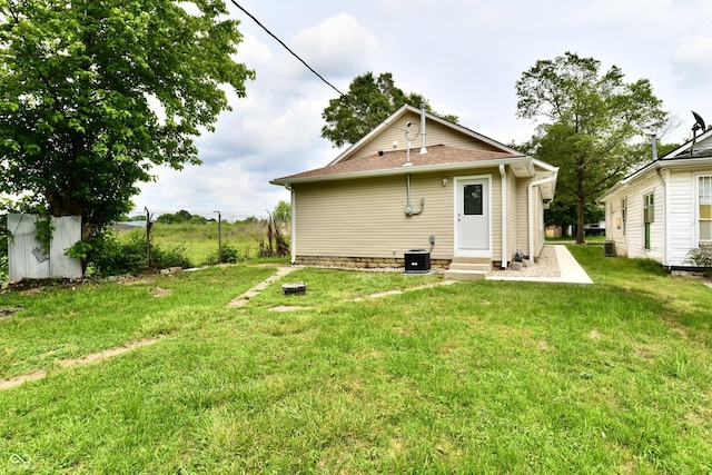 2026 Spruce St, Indianapolis, IN 46203 - back of house featuring entry steps, central AC, and a yard