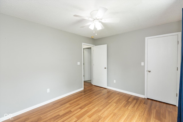 18005 Gasparilla Ct, Westfield, IN 46062 - unfurnished bedroom with light wood finished floors, ceiling fan, and a textured ceiling