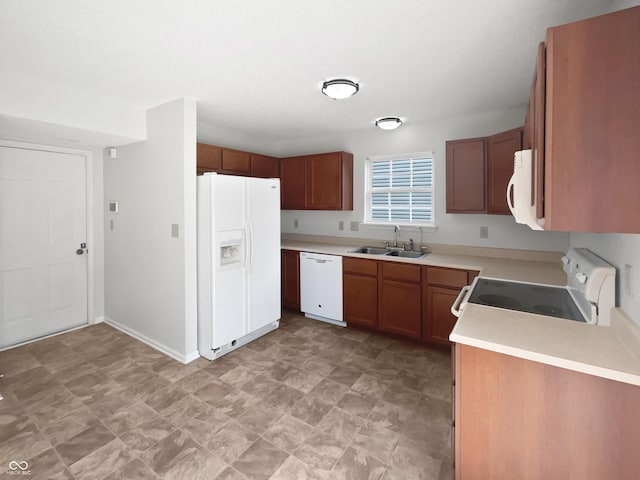 8437 Crosser Dr, Indianapolis, IN 46237 - kitchen with white appliances, a sink, brown cabinets, and light countertops