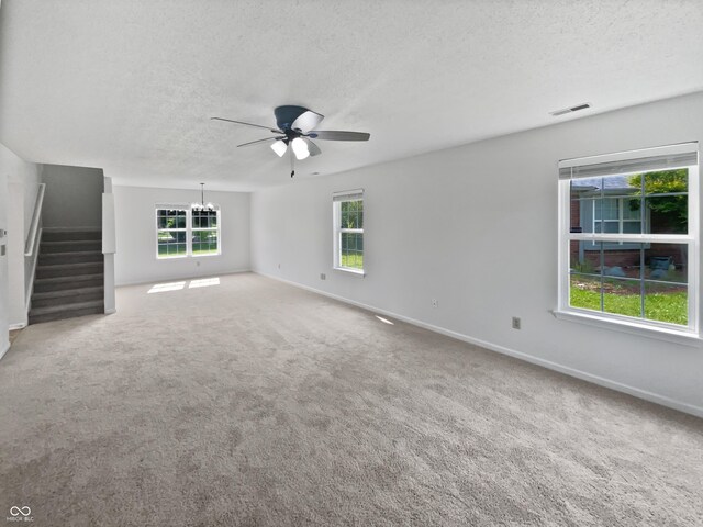 8437 Crosser Dr, Indianapolis, IN 46237 - unfurnished living room featuring a ceiling fan, a textured ceiling, plenty of natural light, and baseboards