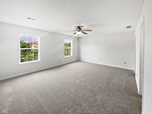 8437 Crosser Dr, Indianapolis, IN 46237 - spare room featuring dark carpet, ceiling fan, baseboards, and a textured ceiling