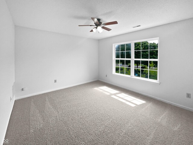 8437 Crosser Dr, Indianapolis, IN 46237 - spare room featuring a ceiling fan, carpet floors, baseboards, and a textured ceiling