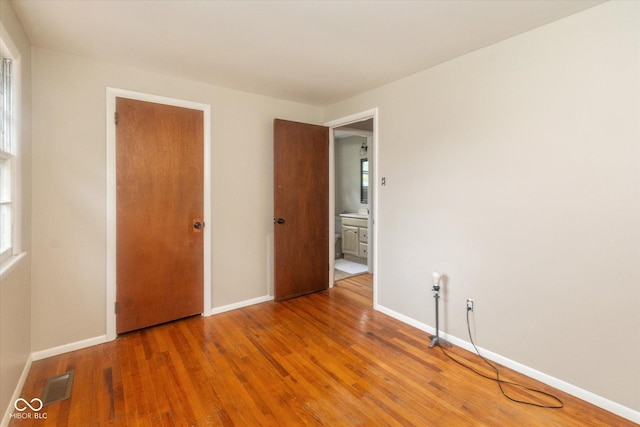 7223 Marla Dr, Indianapolis, IN 46256 - unfurnished bedroom with wood finished floors and baseboards