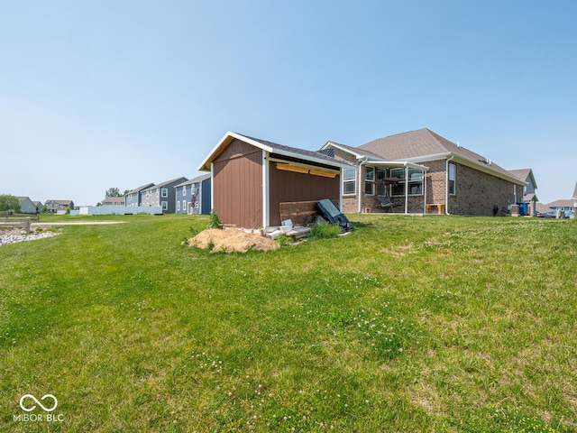 9001 Fitzgerald Dr, Indianapolis, IN 46239 - back of house featuring a yard and brick siding
