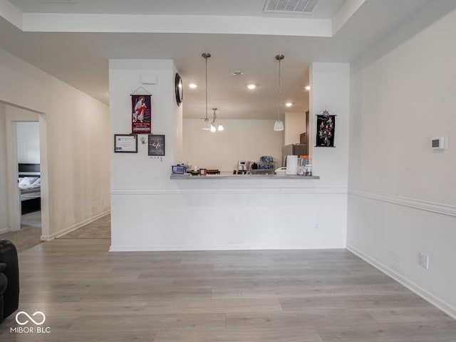 9001 Fitzgerald Dr, Indianapolis, IN 46239 - kitchen with wood finished floors, recessed lighting, freestanding refrigerator, pendant lighting, and light countertops