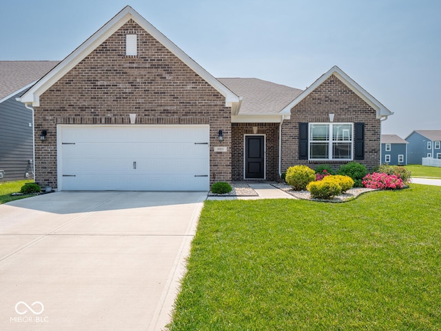 9001 Fitzgerald Dr, Indianapolis, IN 46239 - view of front of property with brick siding, a front yard, driveway, a garage, and a shingled roof