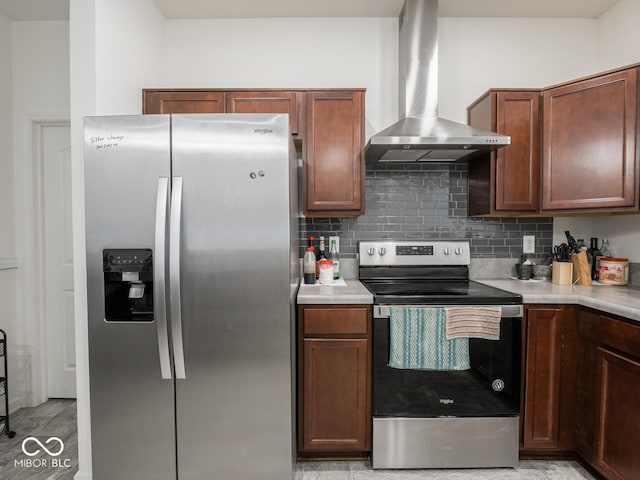 9001 Fitzgerald Dr, Indianapolis, IN 46239 - kitchen featuring appliances with stainless steel finishes, wall chimney range hood, light countertops, and tasteful backsplash