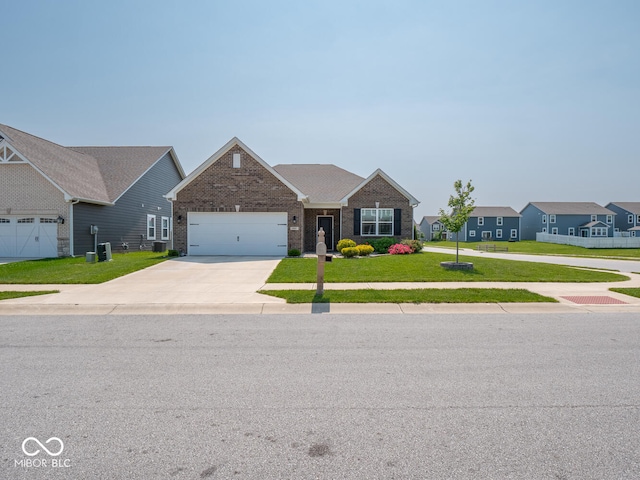 9001 Fitzgerald Dr, Indianapolis, IN 46239 - view of front of home featuring brick siding, driveway, a front yard, and an attached garage