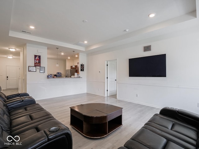 9001 Fitzgerald Dr, Indianapolis, IN 46239 - living area with a tray ceiling, light wood-style floors, and recessed lighting