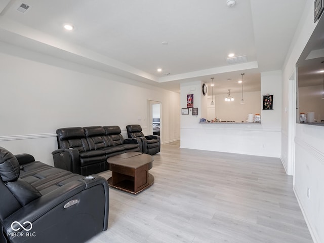 9001 Fitzgerald Dr, Indianapolis, IN 46239 - living room featuring a tray ceiling, light wood-style flooring, and recessed lighting
