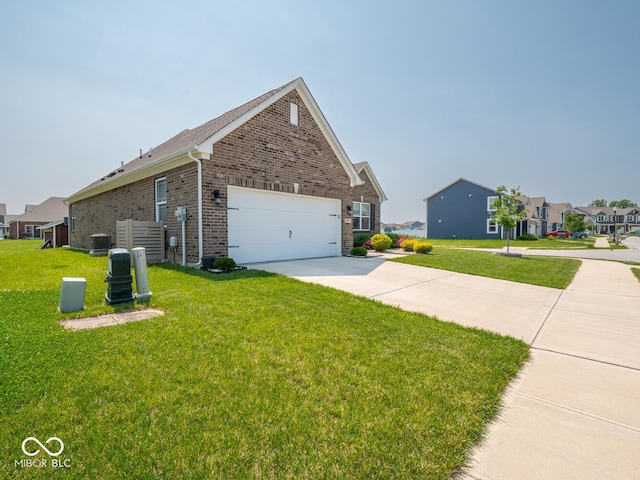 9001 Fitzgerald Dr, Indianapolis, IN 46239 - view of side of home featuring brick siding, driveway, a lawn, and a garage