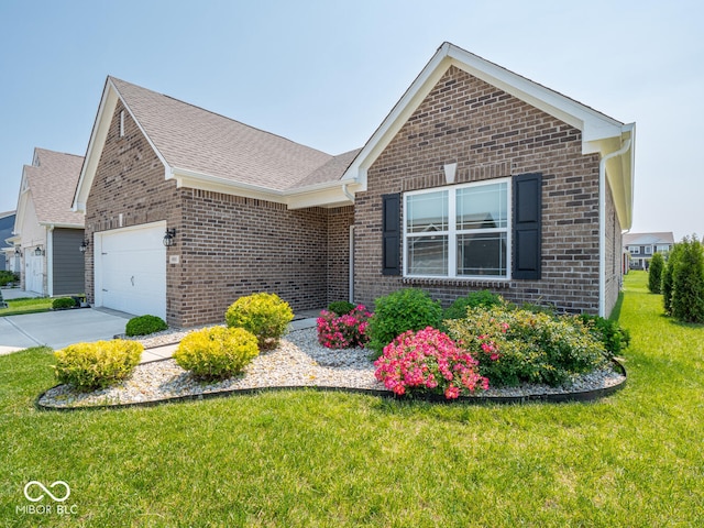 9001 Fitzgerald Dr, Indianapolis, IN 46239 - view of front facade with brick siding, a front lawn, a garage, and concrete driveway