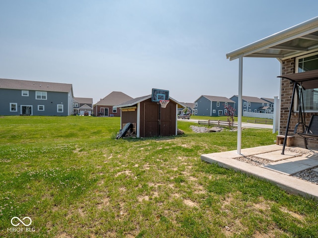 9001 Fitzgerald Dr, Indianapolis, IN 46239 - view of green lawn with a shed and a residential view