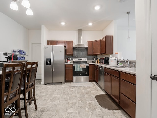 9001 Fitzgerald Dr, Indianapolis, IN 46239 - kitchen with appliances with stainless steel finishes, wall chimney range hood, light countertops, pendant lighting, and backsplash