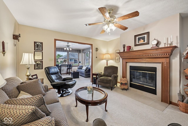 1027 Plum St Unit 39, Brownsburg, IN 46112 - living area featuring carpet flooring, a tiled fireplace, and a ceiling fan