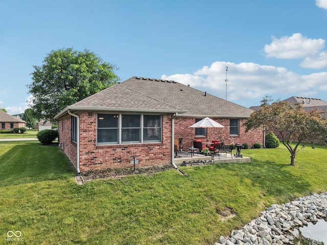 1027 Plum St Unit 39, Brownsburg, IN 46112 - back of house with a patio area, brick siding, a lawn, and a shingled roof