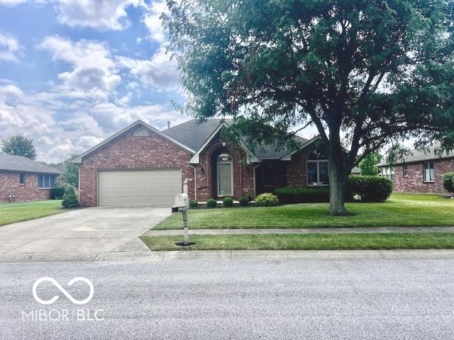 1027 Plum St Unit 39, Brownsburg, IN 46112 - ranch-style home with an attached garage, a front lawn, driveway, and brick siding