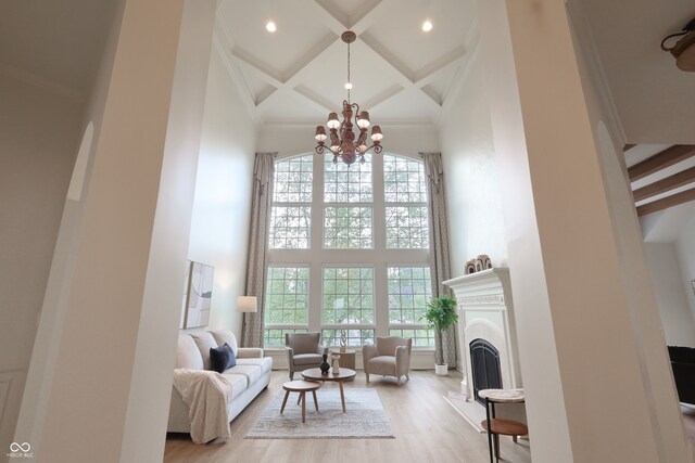 10471 Winghaven Dr, Noblesville, IN 46060 - living room featuring a high ceiling, coffered ceiling, plenty of natural light, beamed ceiling, and a fireplace with raised hearth