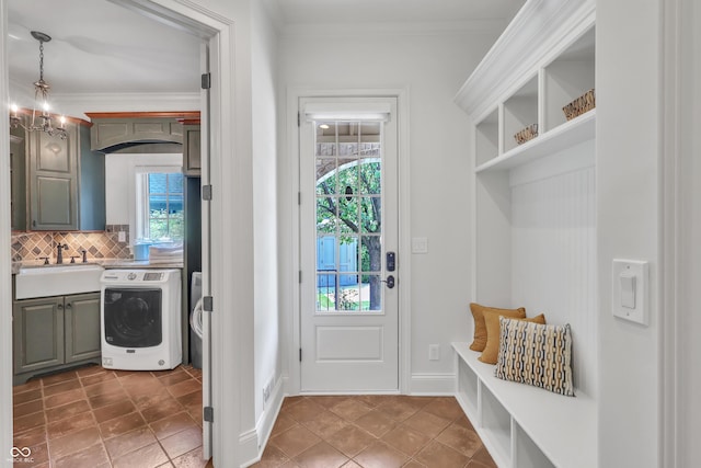 10471 Winghaven Dr, Noblesville, IN 46060 - mudroom with washer / dryer, healthy amount of natural light, ornamental molding, and dark tile patterned flooring