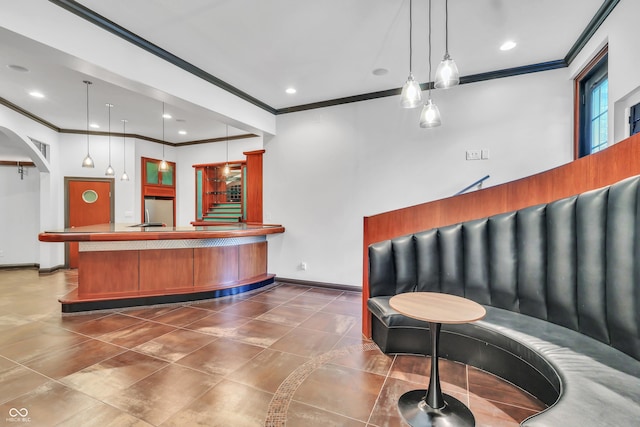 10471 Winghaven Dr, Noblesville, IN 46060 - bar featuring stainless steel refrigerator, ornamental molding, decorative light fixtures, arched walkways, and stairs